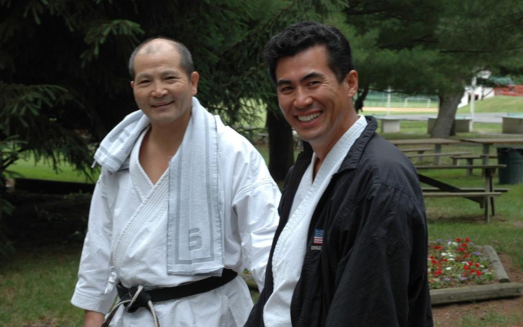 Shihan Shigeru Takashina (1943-2013), seen here with Sensei Yasuaki Nagatomo, 2005 December 2019 Katas of the Month: Heian Shodan Unsu, Bassai Dai 1 2 3